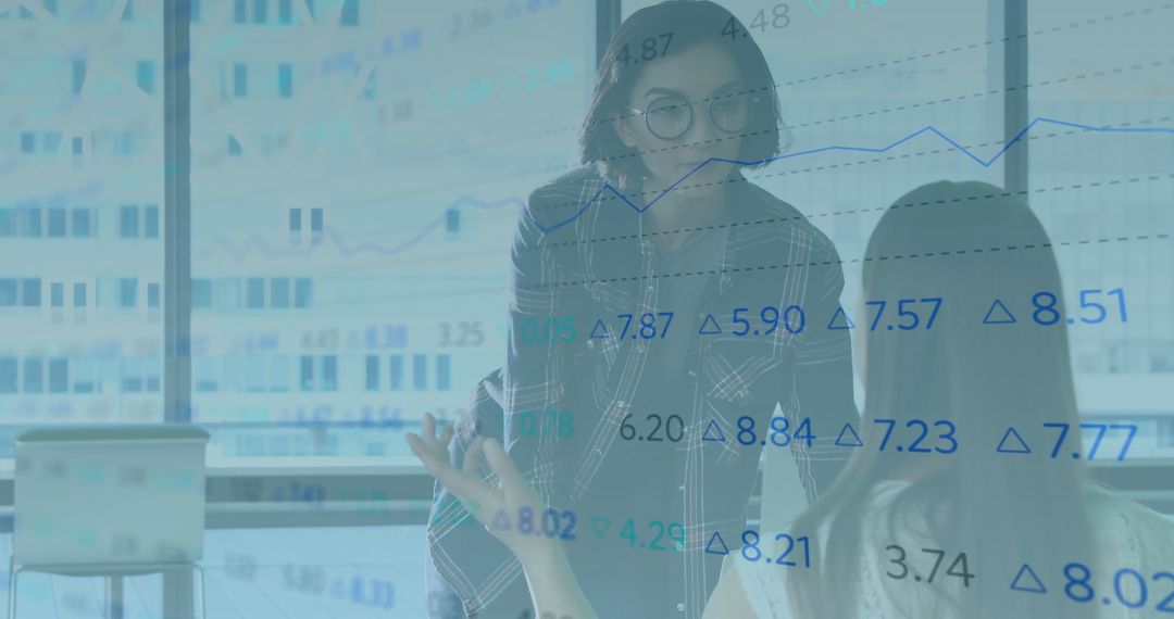 Professional Women Analyzing Financial Data in Business Setting