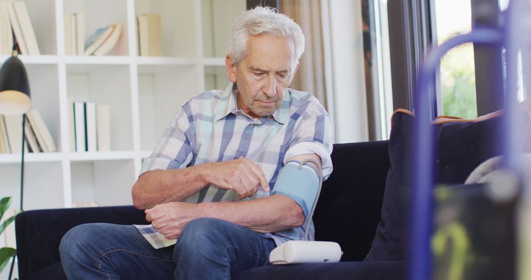 Elderly man measuring blood pressure at home - Free Images, Stock Photos and Pictures on Pikwizard.com