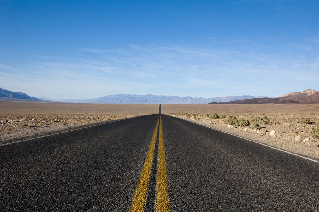 Desert highway road stretching into horizon