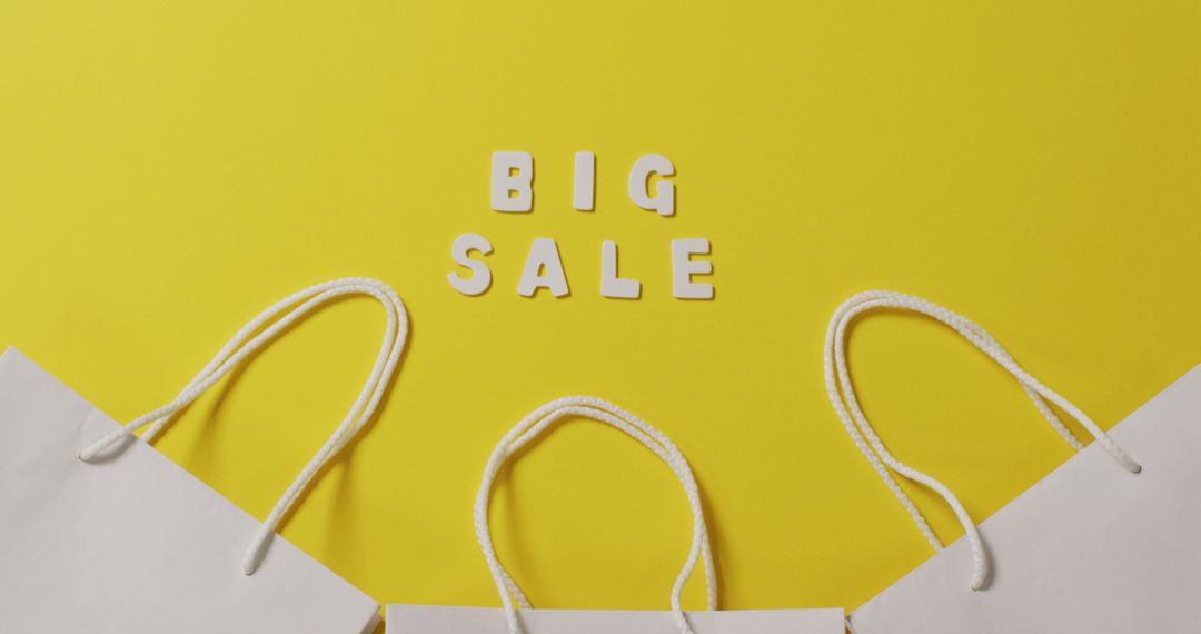 Big Sale Announcement with White Paper Bags on Yellow Background - Free Images, Stock Photos and Pictures on Pikwizard.com