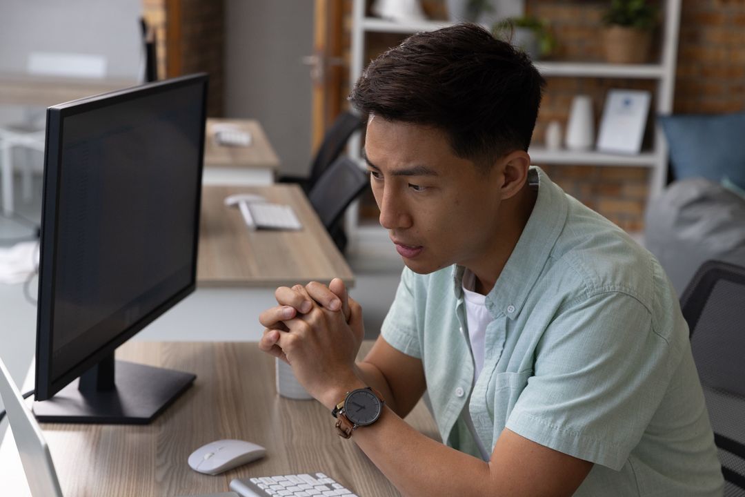 Focused Young Professional Working In Modern Office Setting