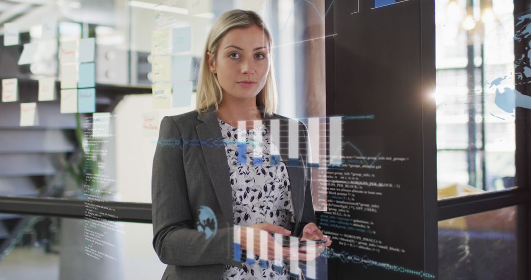 Female Professional Analyzing Data Through Transparent Screen in Modern Office - Free Images, Stock Photos and Pictures on Pikwizard.com