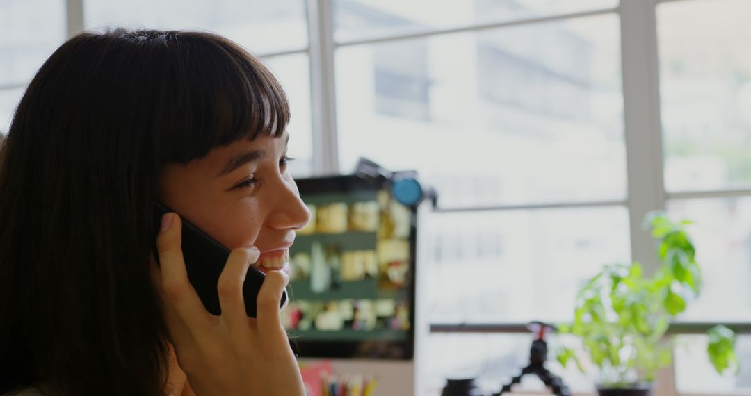 Caucasian Graphic Designer Talking on Mobile Phone in Modern Office