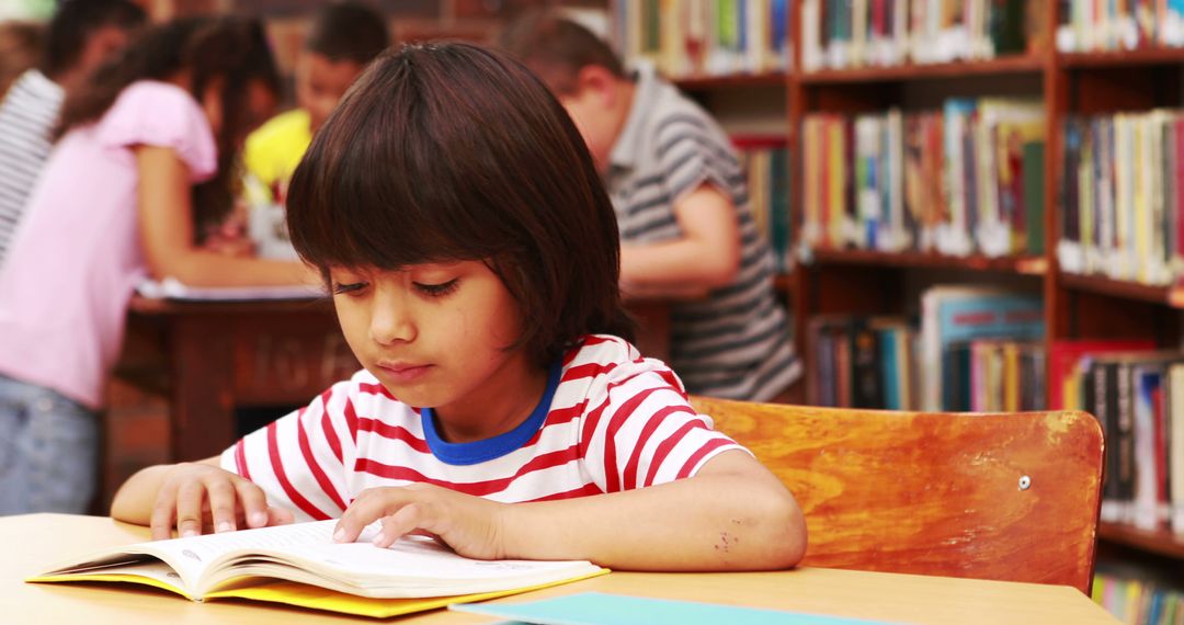 Young Boy Reading Book in Library - Free Images, Stock Photos and Pictures on Pikwizard.com