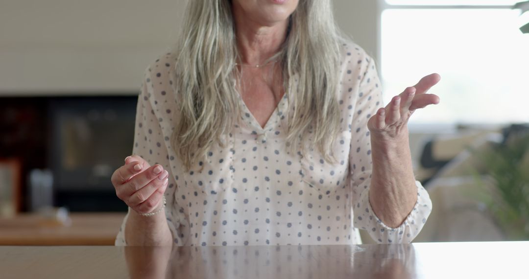 Senior Woman Gesturing While Talking at Home