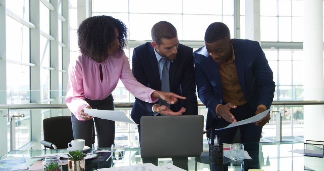 Diverse Business Team Collaborating on Laptop Project in Modern Office