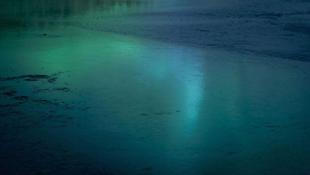 Glowing Turquoise Water Reflecting Twilight Light over Glassy Lake Surface