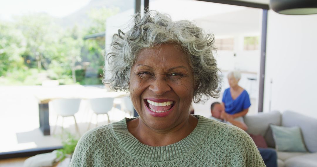 Happy Senior Africal American Woman Laughing at Home - Free Images, Stock Photos and Pictures on Pikwizard.com