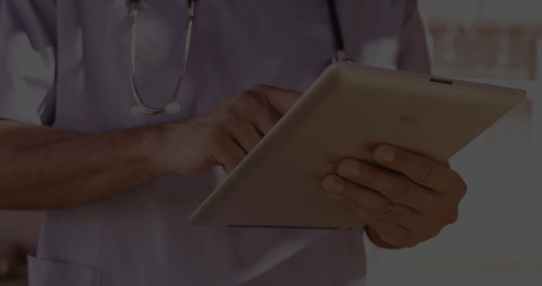 Clinician Using Tablet Technology in Hospital Environment