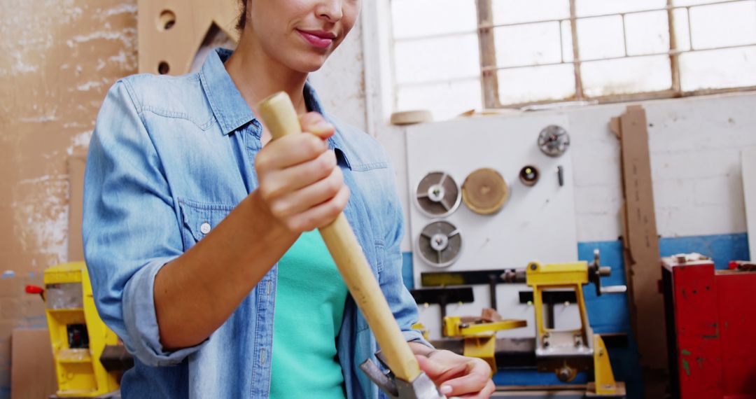 Female Carpenter Removing Nail from Wooden Plank in Workshop - Free Images, Stock Photos and Pictures on Pikwizard.com