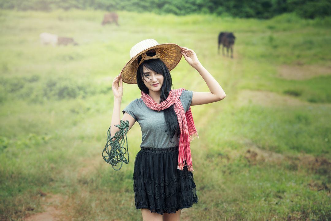 Young Woman in Countryside Wearing Straw Hat and Red Scarf - Free Images, Stock Photos and Pictures on Pikwizard.com