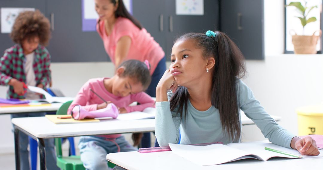 Girl Daydreaming in Classroom While Classmates Study