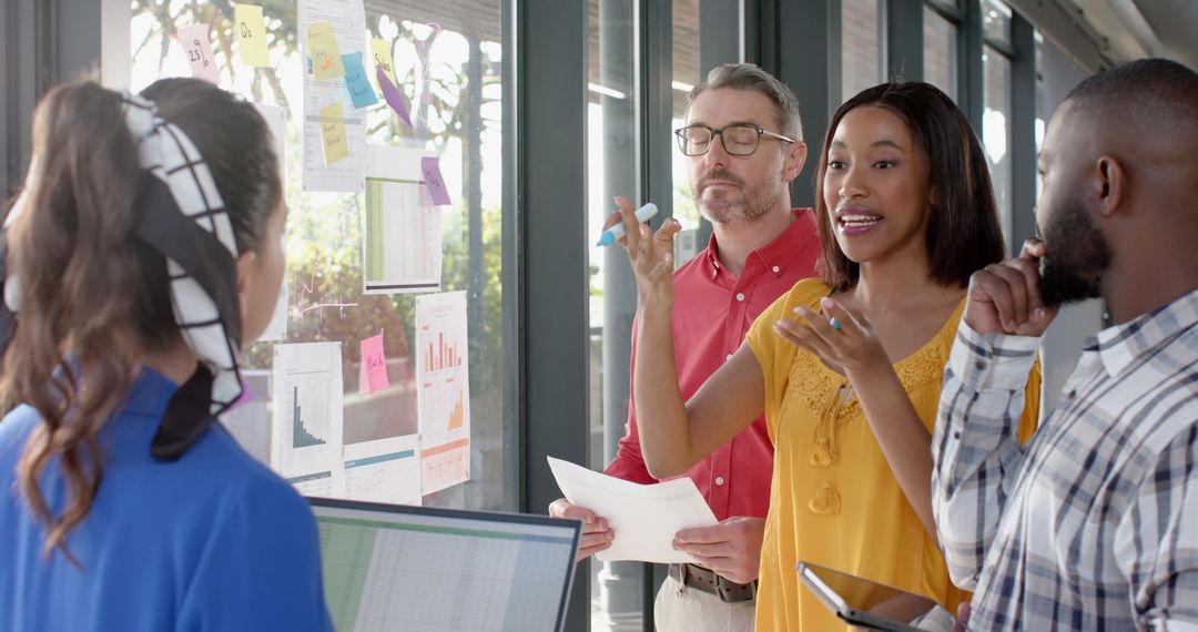 Diverse Team Collaborating on Office Project with Shared Ideas