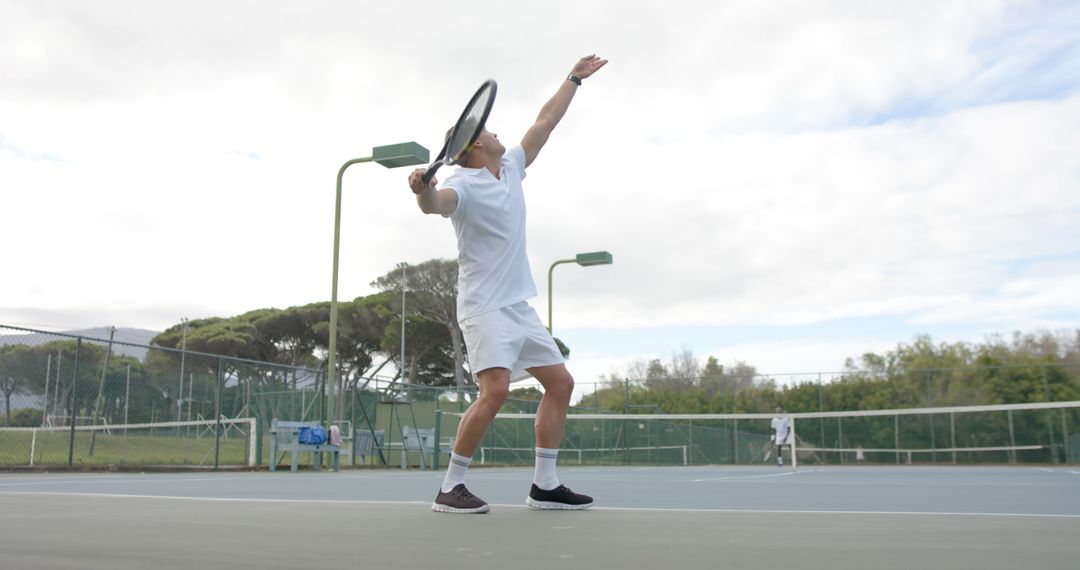 Man Serving Tennis Ball on Outdoor Court - Free Images, Stock Photos and Pictures on Pikwizard.com