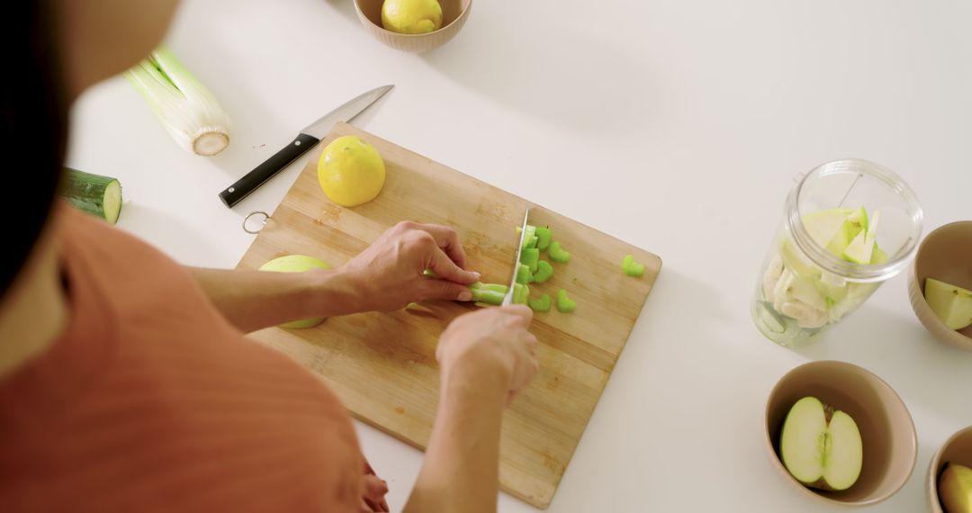 Woman Chopping Celery for Healthy Meal on Clean Counter