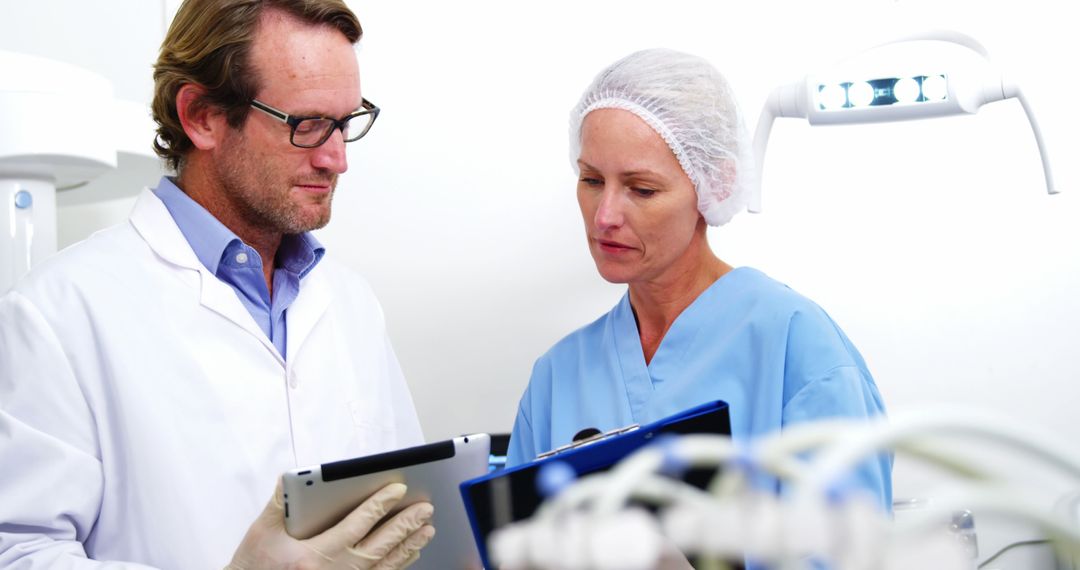 Doctors Collaborating on Digital Tablet in Medical Facility - Free Images, Stock Photos and Pictures on Pikwizard.com