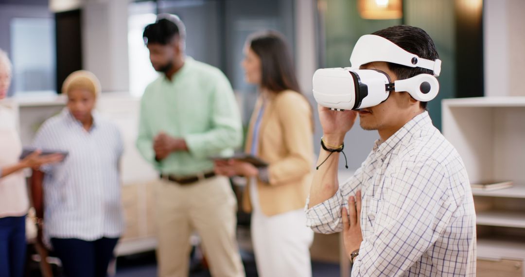 Engineer Testing VR Headset During Team Meeting in Modern Office