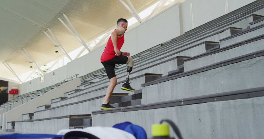 Amputee athlete training hard running up stadium stairs - Free Images, Stock Photos and Pictures on Pikwizard.com