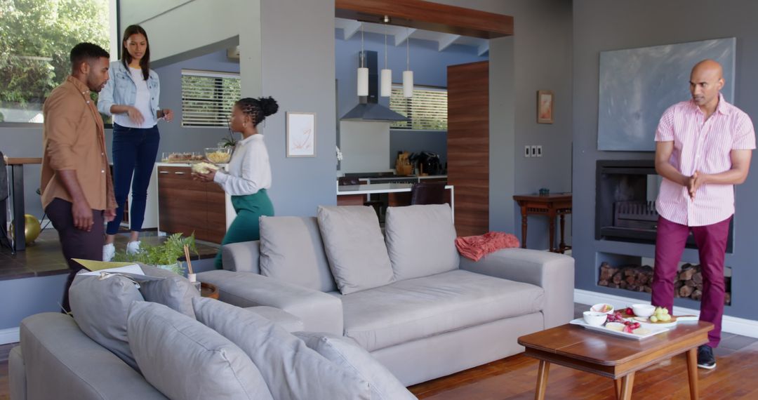 Multiracial Friends Setting Up for Birthday Party in Stylish Living Room
