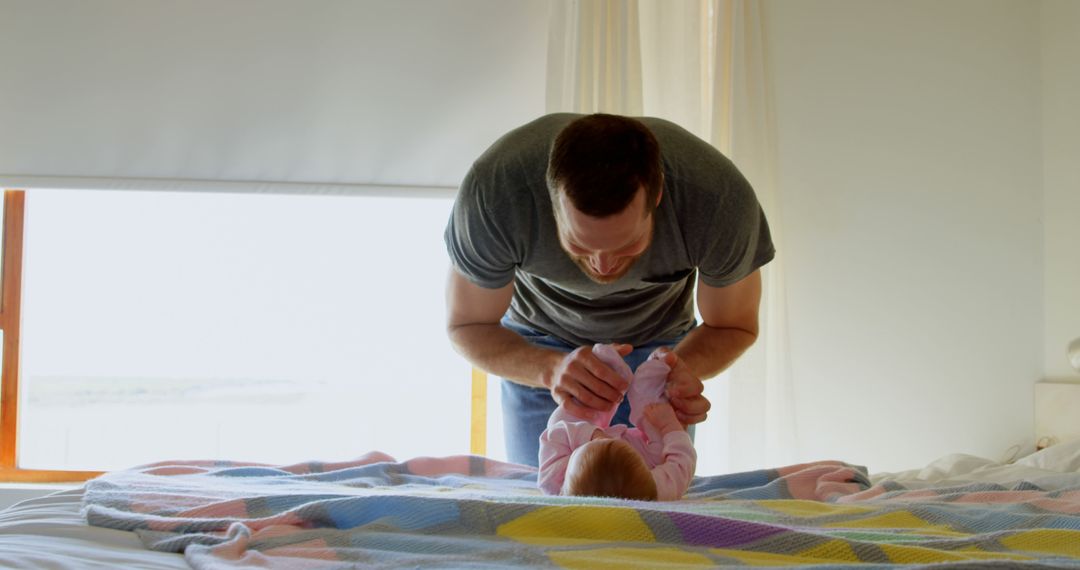 Father Changing Baby Diaper in Bedroom - Free Images, Stock Photos and Pictures on Pikwizard.com