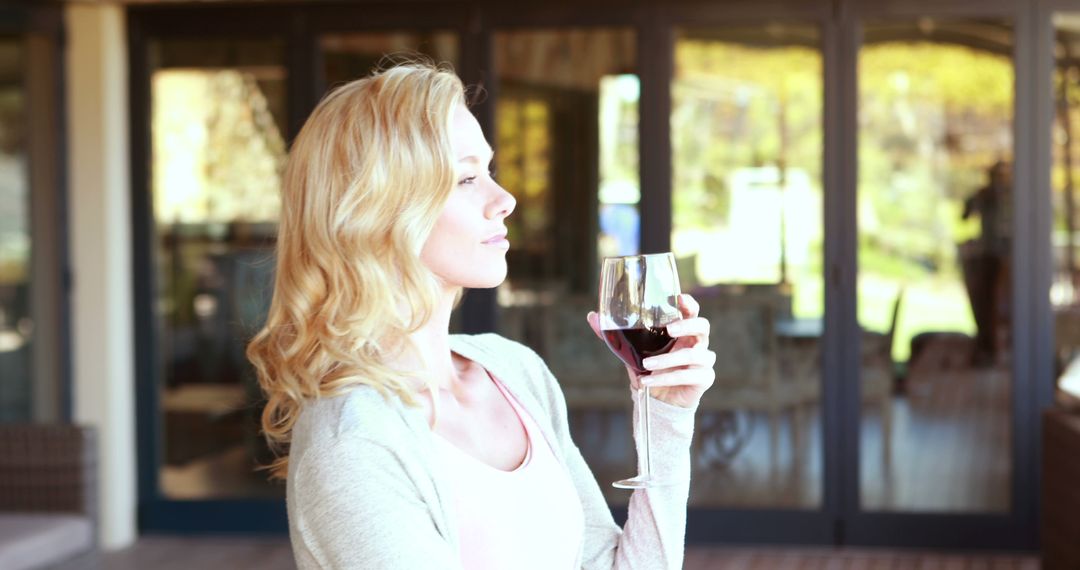 Relaxed Woman Enjoying Glass of Wine on Patio - Free Images, Stock Photos and Pictures on Pikwizard.com