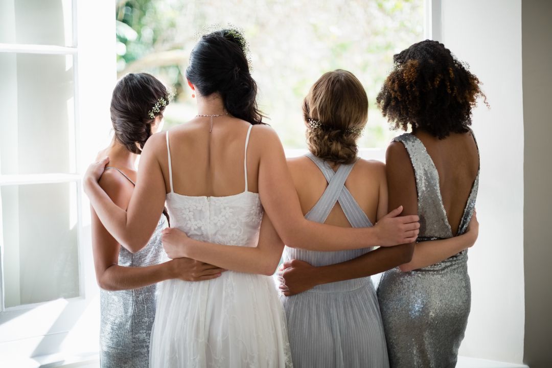Bride and Bridesmaids Embracing Near Window - Free Images, Stock Photos and Pictures on Pikwizard.com