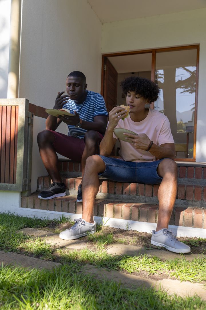 Diverse Friends Enjoying Burgers on Rustic Porch Steps