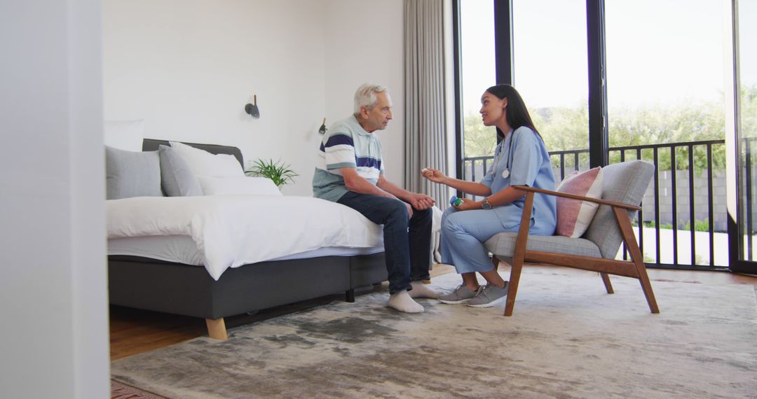 Image of biracial female doctor giving pills to caucasian senior man - Free Images, Stock Photos and Pictures on Pikwizard.com