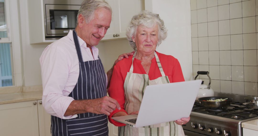 Senior Couple Using Laptop in Kitchen - Free Images, Stock Photos and Pictures on Pikwizard.com