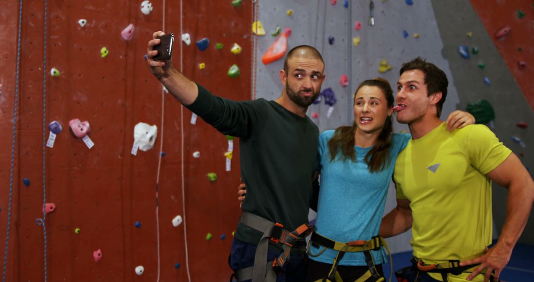 Friends Taking Selfie at Indoor Climbing Gym in Safety Gear - Free Images, Stock Photos and Pictures on Pikwizard.com