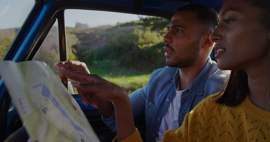 Couple in Car Analyzing Map for Outdoor Adventure Exploration
