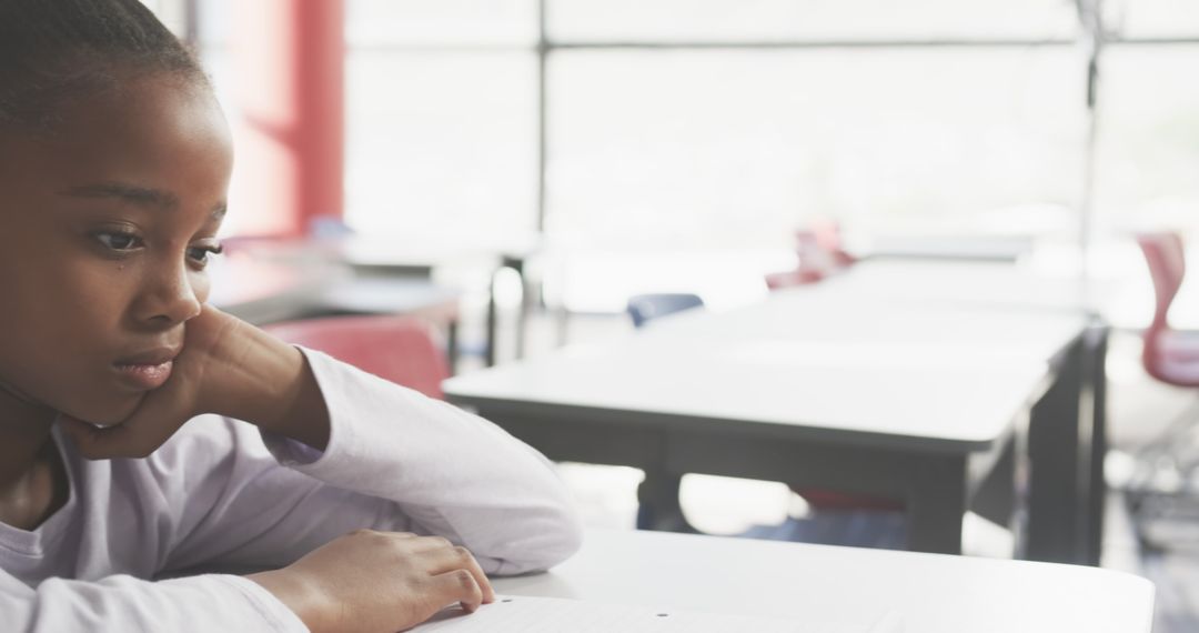Young Student at Desk Reading, Focused on Learning