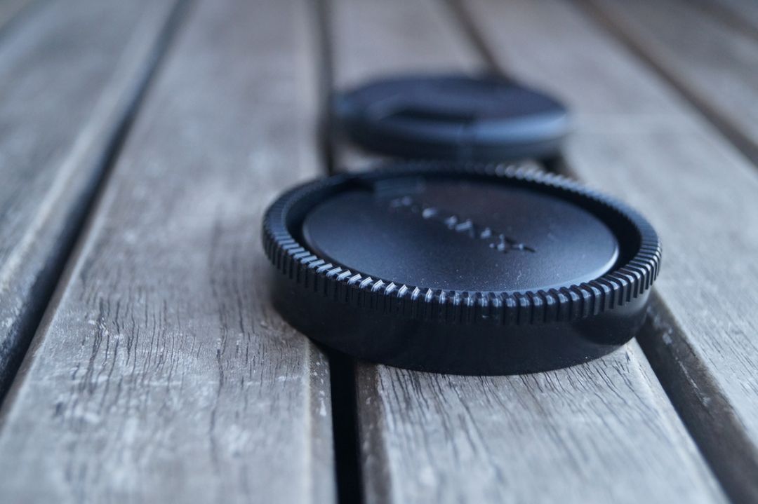 Lens Cap on Wooden Surface - Free Images, Stock Photos and Pictures on Pikwizard.com