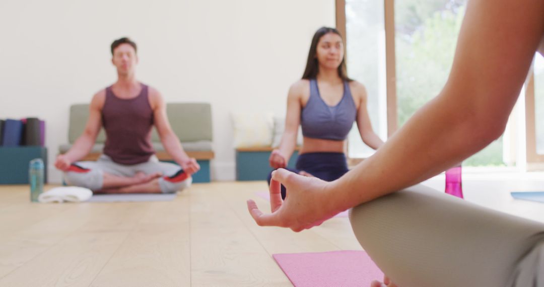 Diverse Multi-Ethnic Group Practicing Mindful Yoga with Instructor