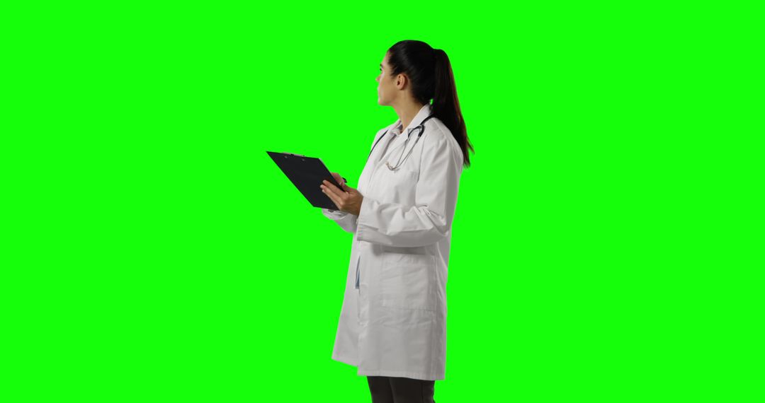 Female Doctor Reviewing Patient Medical Records on Green Screen Background - Free Images, Stock Photos and Pictures on Pikwizard.com