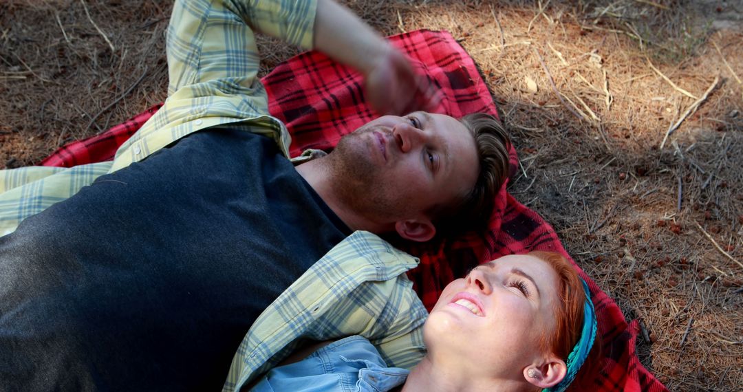 Couple Relaxing on Red Plaid Blanket Outdoors in Sunlight - Free Images, Stock Photos and Pictures on Pikwizard.com