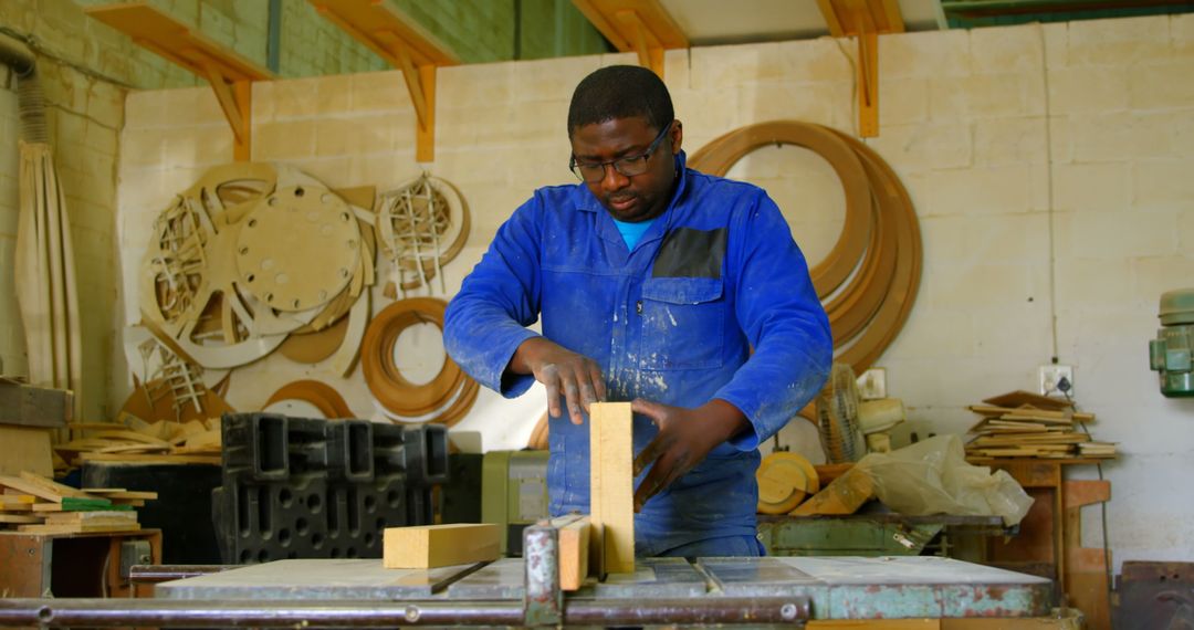 Carpenter Focused on Shaping Wooden Block in Workshop