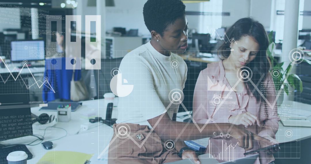 Collaborative Businesswomen Analyzing Digital Financial Data in Office