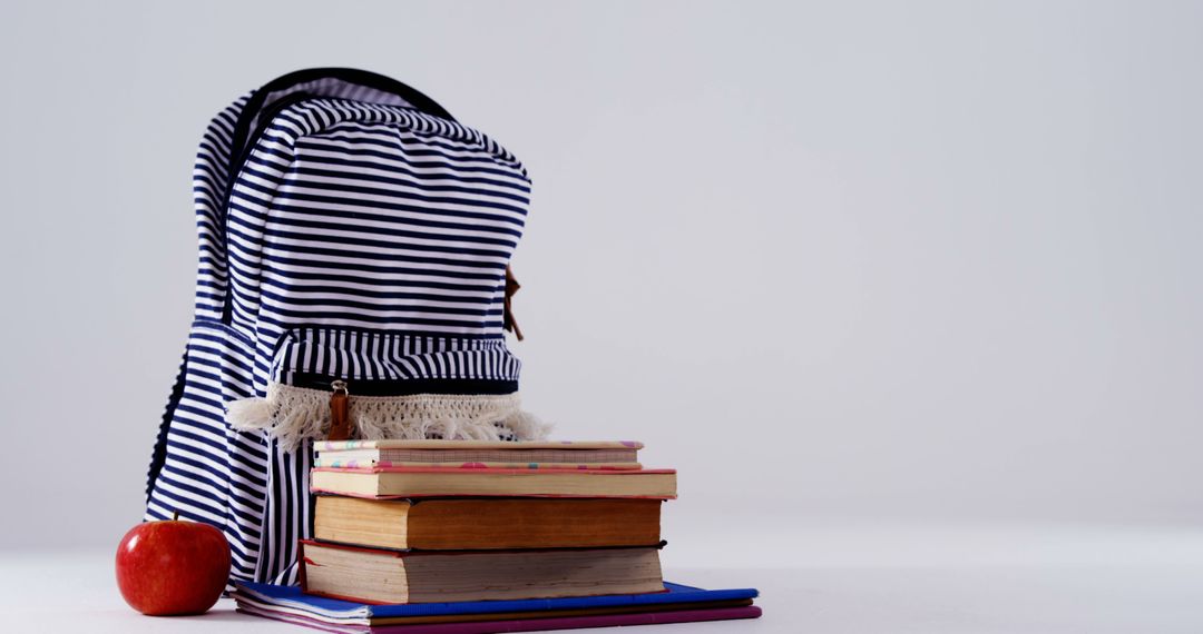 Backpack and Books with Apple Suggesting School Preparation