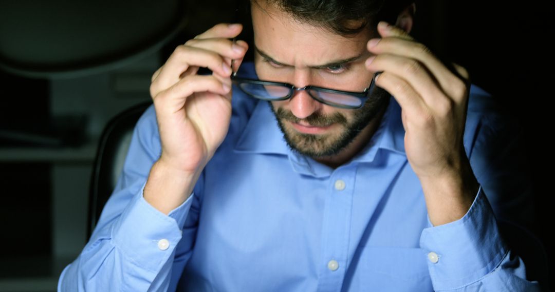 Man Focusing on Screen in Dark Office - Free Images, Stock Photos and Pictures on Pikwizard.com