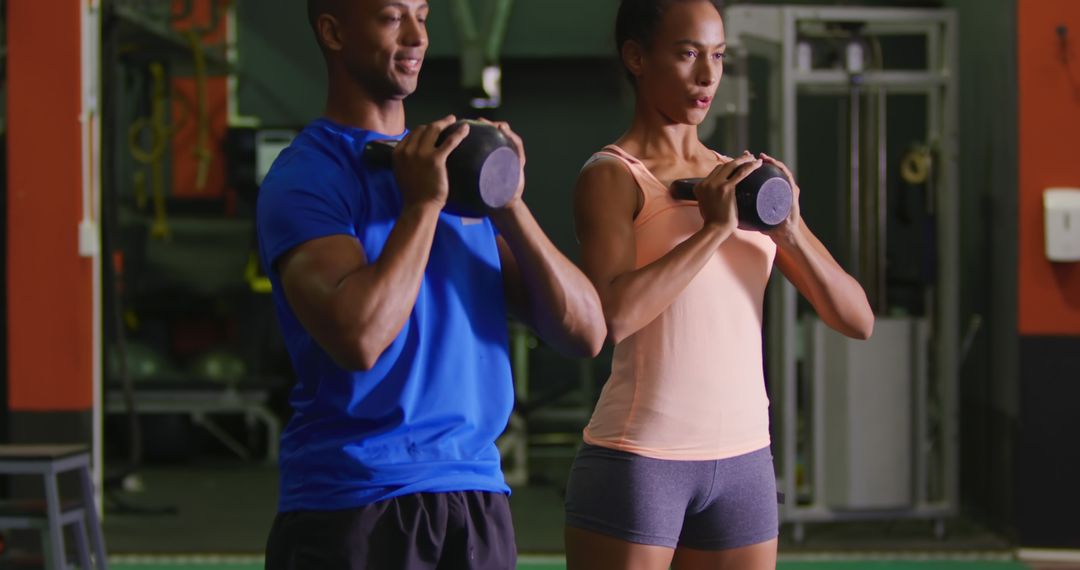 Fit Couple Strength Training with Dumbbells in Gym - Free Images, Stock Photos and Pictures on Pikwizard.com