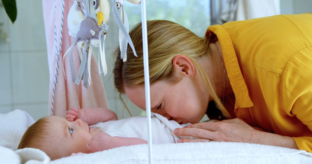 Mother Kissing Her Baby in Nursery - Free Images, Stock Photos and Pictures on Pikwizard.com