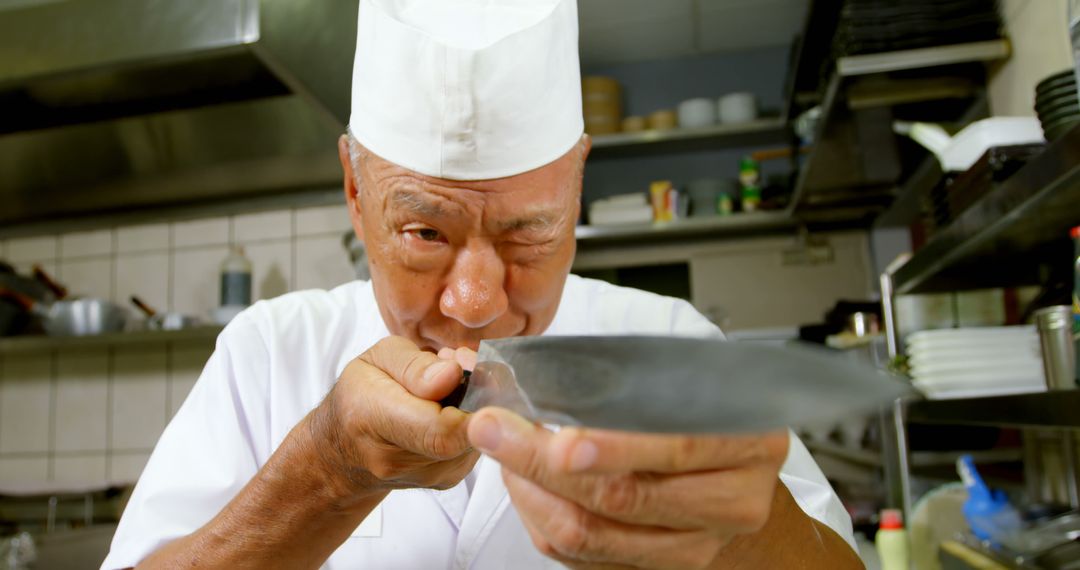 Senior Chef Testing Flavors in Professional Kitchen