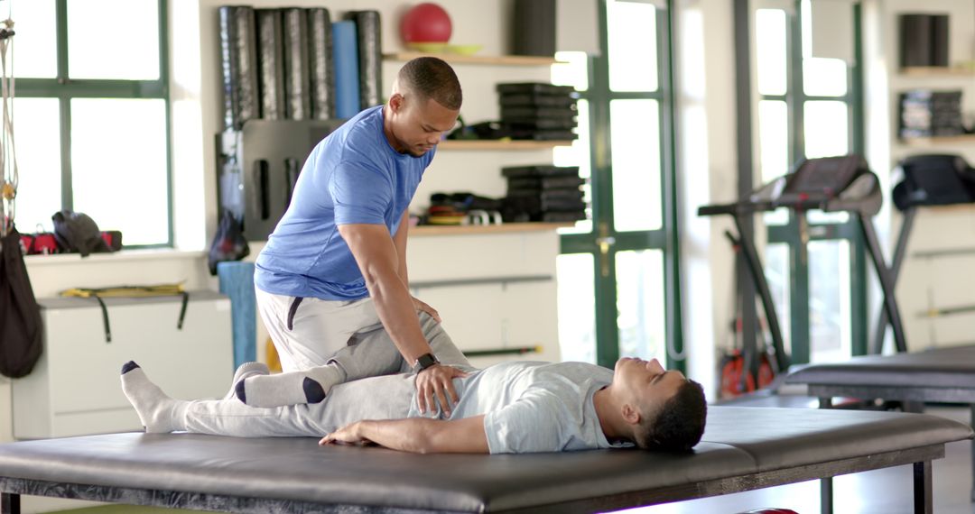 Physical Therapist Assisting with Leg Rehabilitation in Modern Facility