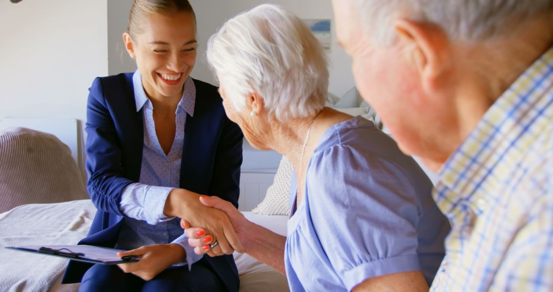 Smiling Elderly Couple Meeting with Financial Advisor at Home - Free Images, Stock Photos and Pictures on Pikwizard.com