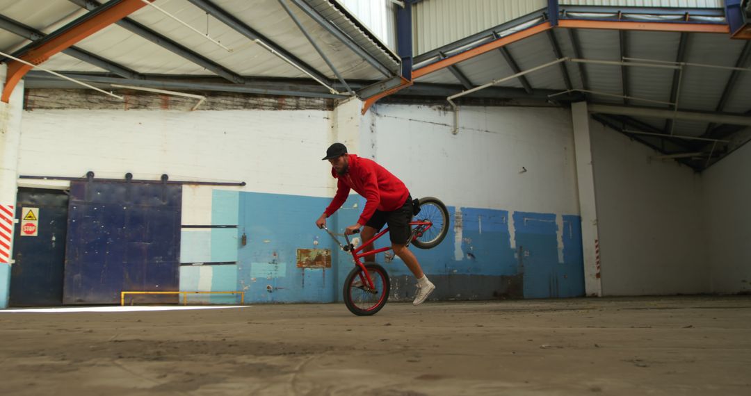 Young Man Performing BMX Stunt in Abandoned Warehouse - Free Images, Stock Photos and Pictures on Pikwizard.com