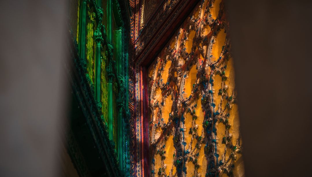 Intricate Gold-Toned Temple Panel with Colored Glass