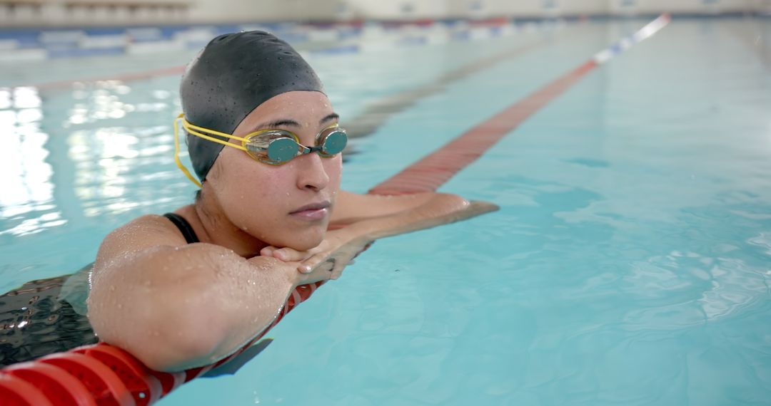 Female Swimmer Resting at Pool Edge in Swimwear