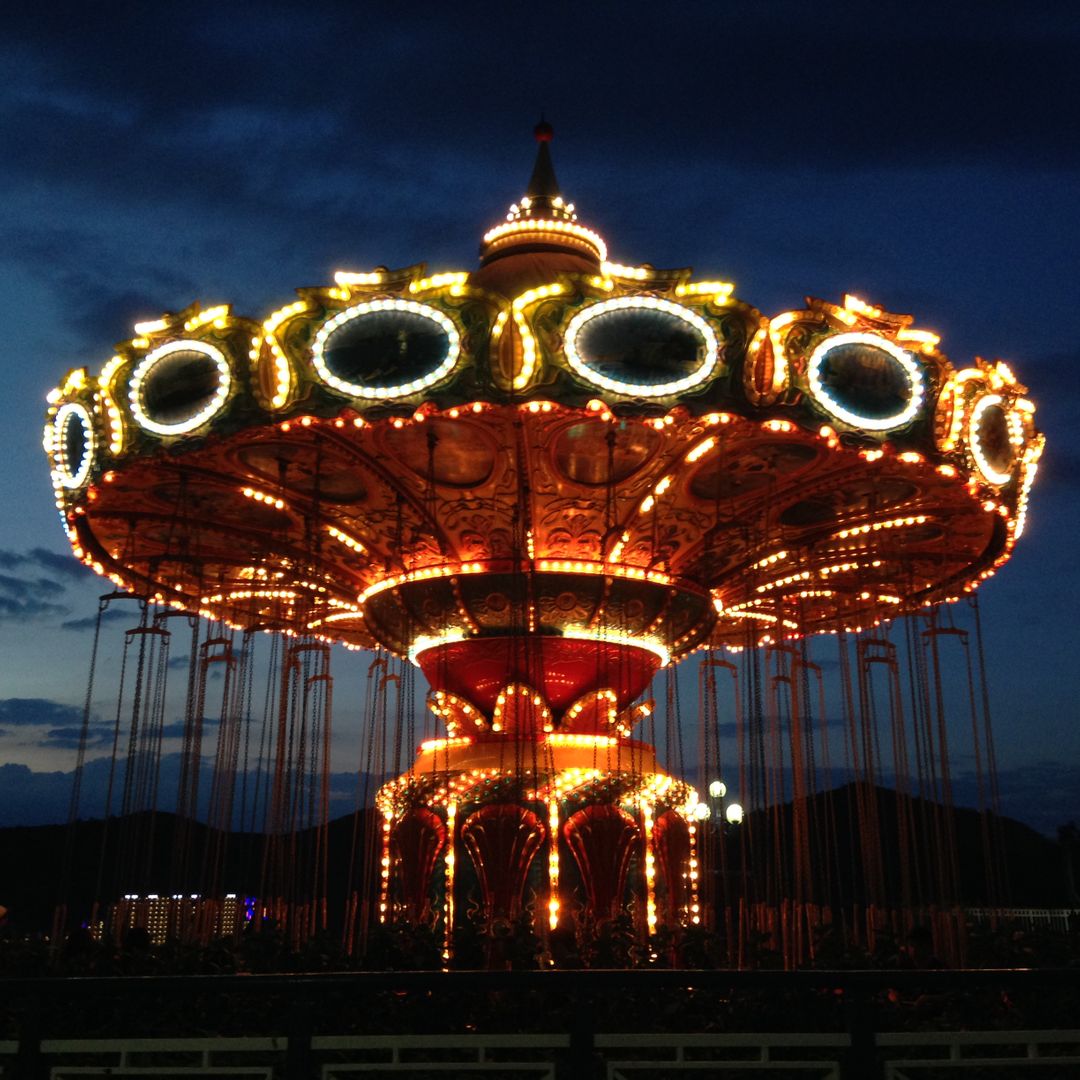 Illuminated Swing Ride at Night in Amusement Park - Free Images, Stock Photos and Pictures on Pikwizard.com