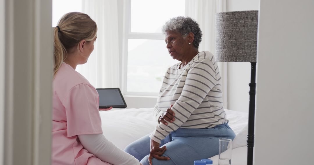 Nurse Discussing Health with Senior African American Patient at Home - Free Images, Stock Photos and Pictures on Pikwizard.com